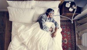 Man sleeping with an anti-snoring mask on
