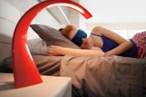 Woman In Bed Sleeping With Sleep Mask On Eyes